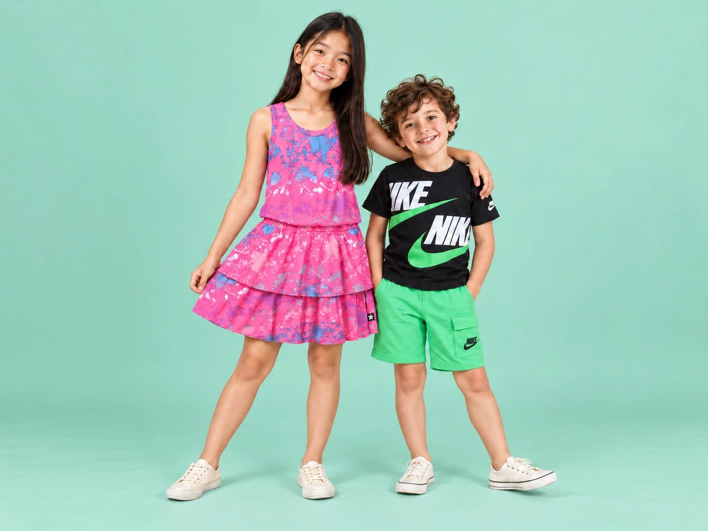 Hana and Eli modeling a pink splatter-print dress and a black-and-green Nike outfit