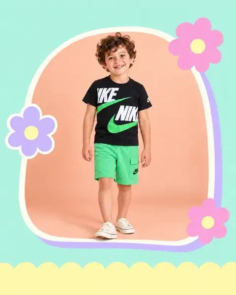 Boy wearing a black Nike shirt and green shorts