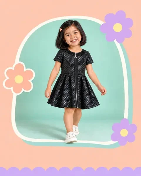 Girl wearing a glossy black quilted dress
